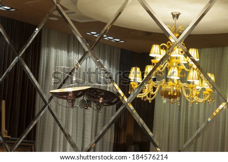 Mirror wall in a hotel - reflection of the chandelier in the mirror