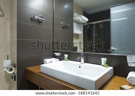 Modern tap and water basin in hotel bathroom