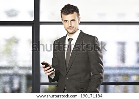 Handsome businessmen holding the cell phone  in the office