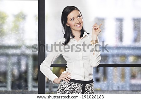 Successful businesswoman in the office smiling and thinking