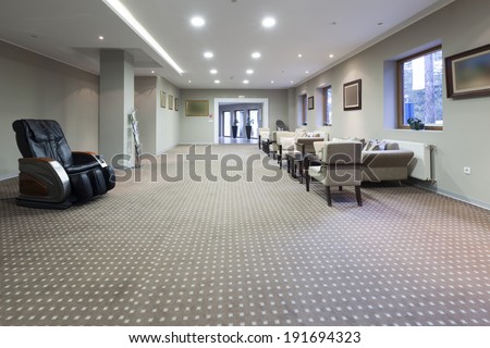 Hotel lobby interior with cafe and massage chair