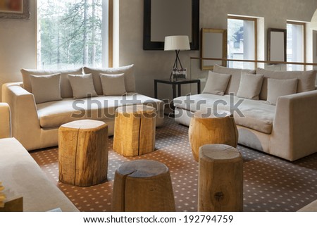 Modern hotel lobby cafe interior with logs as chairs