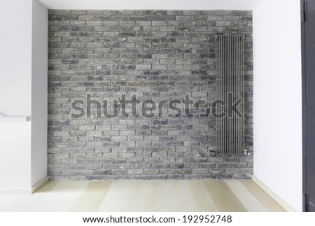 Brick wall with modern steam heat radiator