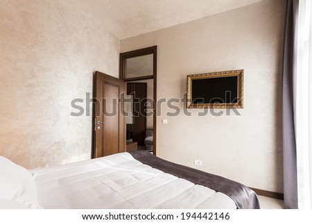 Hotel bedroom with framed wall mounted tv
