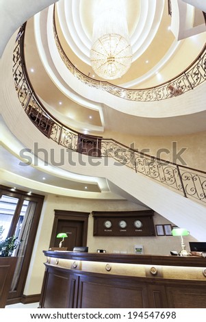 Reception area with reception desk and luxury spiral stairs