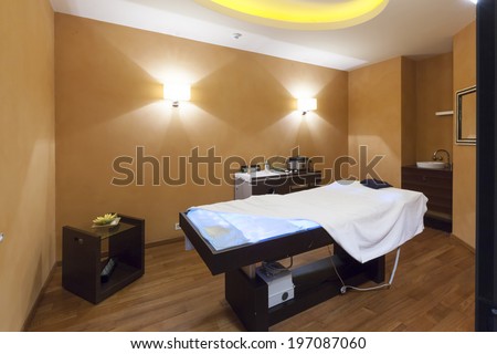 Interior of a room for stone massage with special therapeutic lights in massage bed