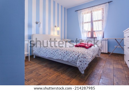 Interior of a simple bedroom with blue walls