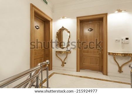 Two wooden doors in hotel corridor