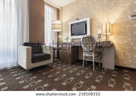 Interior of a modern hotel room with wall mounted tv