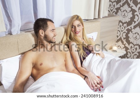 Attractive handsome couple lying in the bed