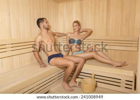 Attractive handsome couple relaxing in sauna