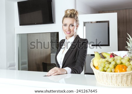 Attractive young hotel receptionist at her workplace