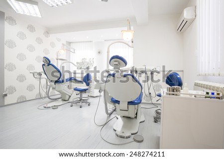 interior of a dental room with blue dental chairs