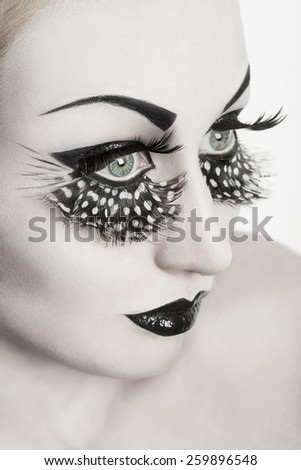 Gorgeous young model with perfect art make up and long false eyelashes