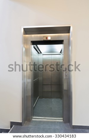 Open elevator door in hotel lobby