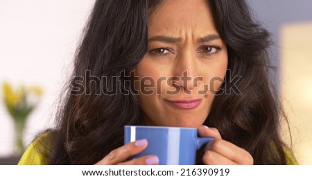 Mexican woman making a funny face with mug