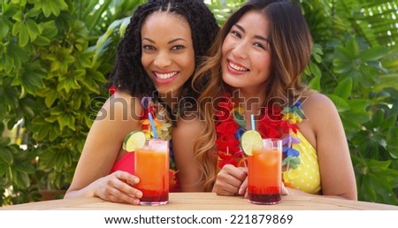 Black and Asian best friends enjoying tropical vacation together