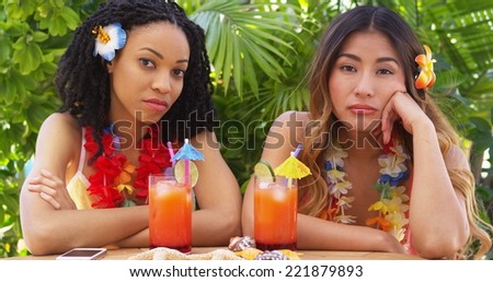 Bored African American and Asian women on vacation