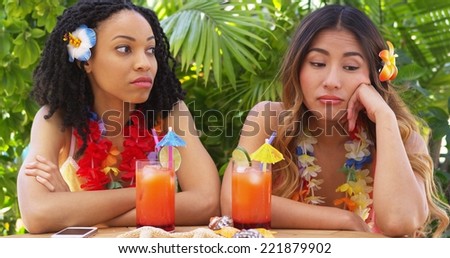 Bored African American and Asian women on vacation