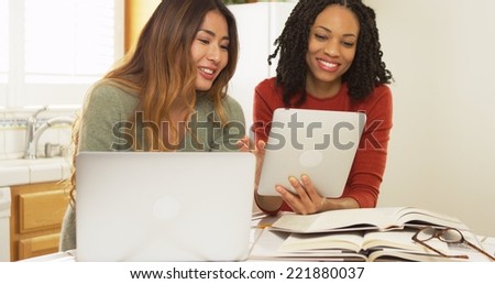 Japanese and Black friends studying for university with laptop computer