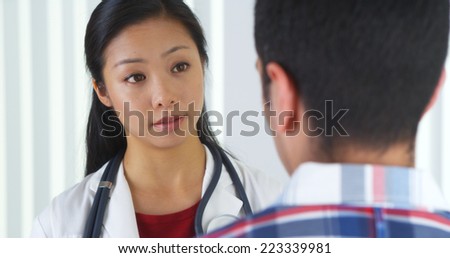 Chinese doctor talking to patient