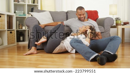 Black couple sitting on floor talking