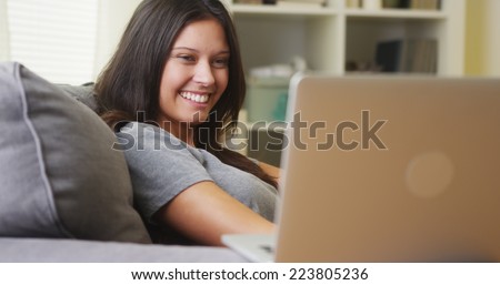 Young woman watching videos on laptop