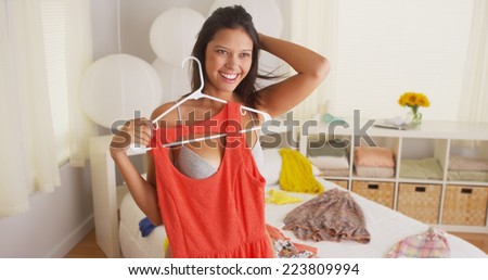 Young Mixed race woman trying to figure out what to wear