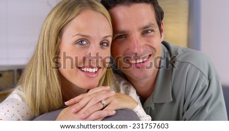 Happy white couple sitting on couch
