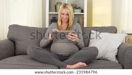 Pregnant woman browsing the web on tablet