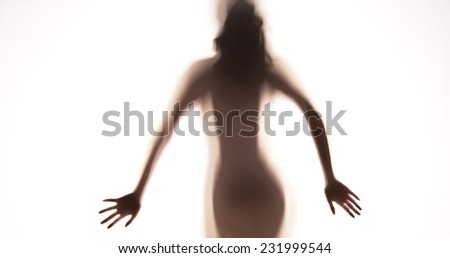 Attractive Mexican woman standing behind curtain