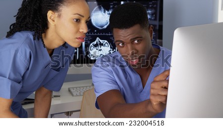 Two African American Medical specialists using computers