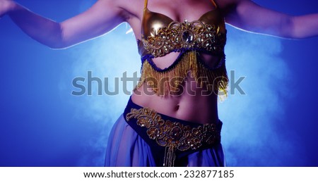 Close up of belly dancer in blue and gold