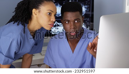 Female medical specialist working with colleague on computer