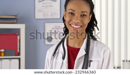 Close up Portrait of Black female doctor smiling in medical clinic