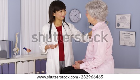 Chinese doctor talking to elderly patient