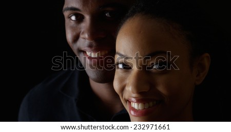 Dramatic rack focus between smiling young black man and woman