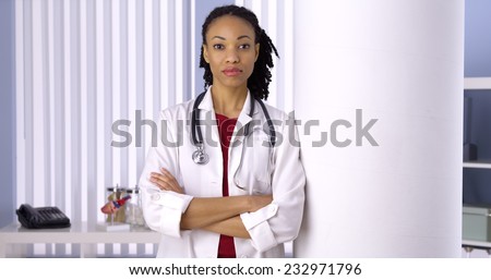 Successful black woman doctor standing in office