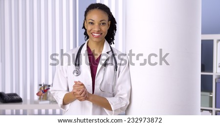 Successful black woman doctor smiling in office