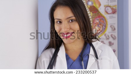 Hispanic obstetrician standing in office