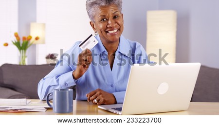Happy Mature African woman approved with new credit card