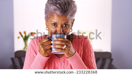 Mature black woman smiling with coffee mug