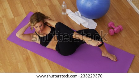 Healthy young woman working out in home gym