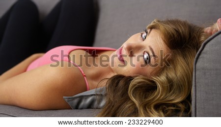 Pretty girl lying on couch smiling