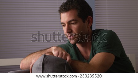 Guy sitting on couch thinking