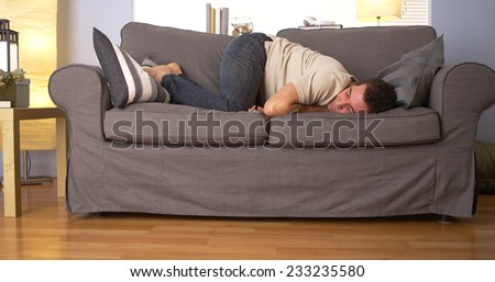 Man trying to sleep on couch