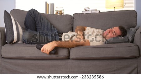 Guy trying to sleep on couch