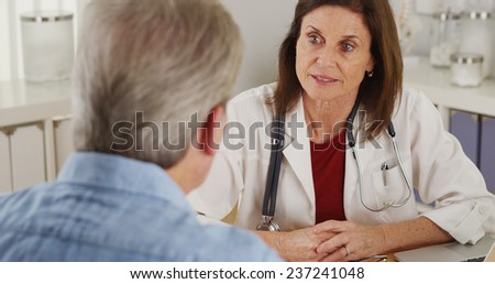 Senior doctor advising elderly patient