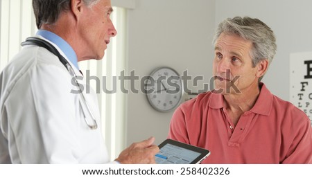Senior doctor and patient talking in the office