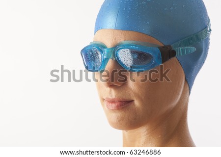 stock-photo-close-up-portrait-of-young-woman-with-swim-cap-and-swimming-goggles-63246886.jpg